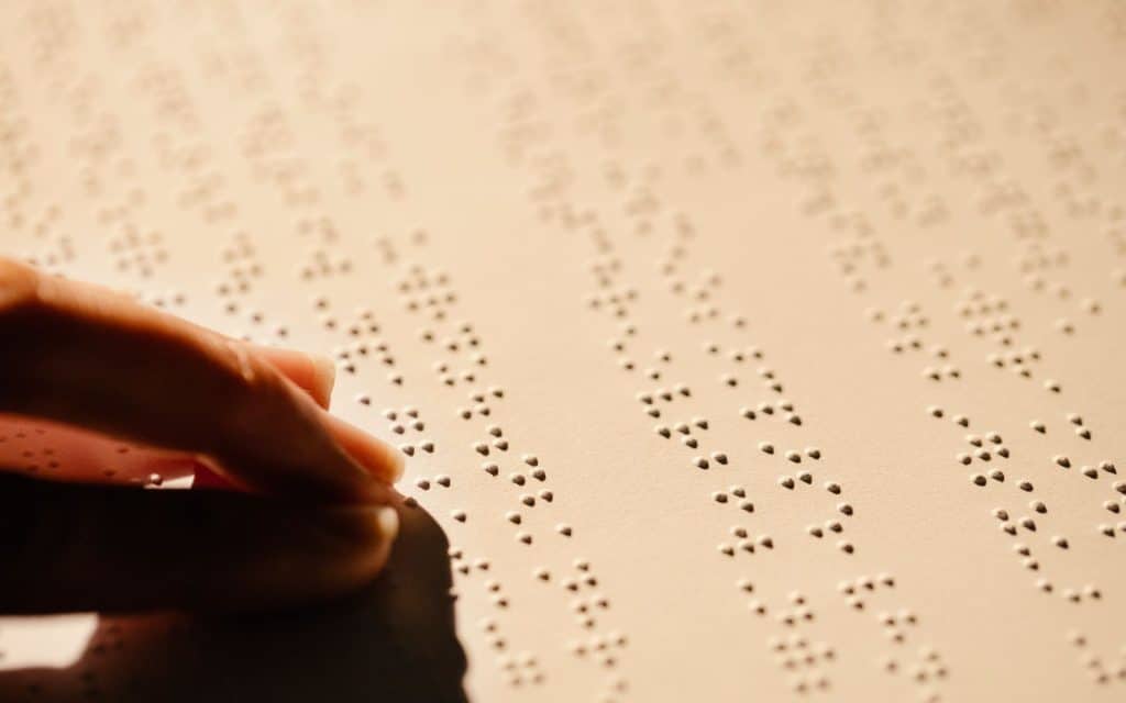 Close-up of a hand reading braille