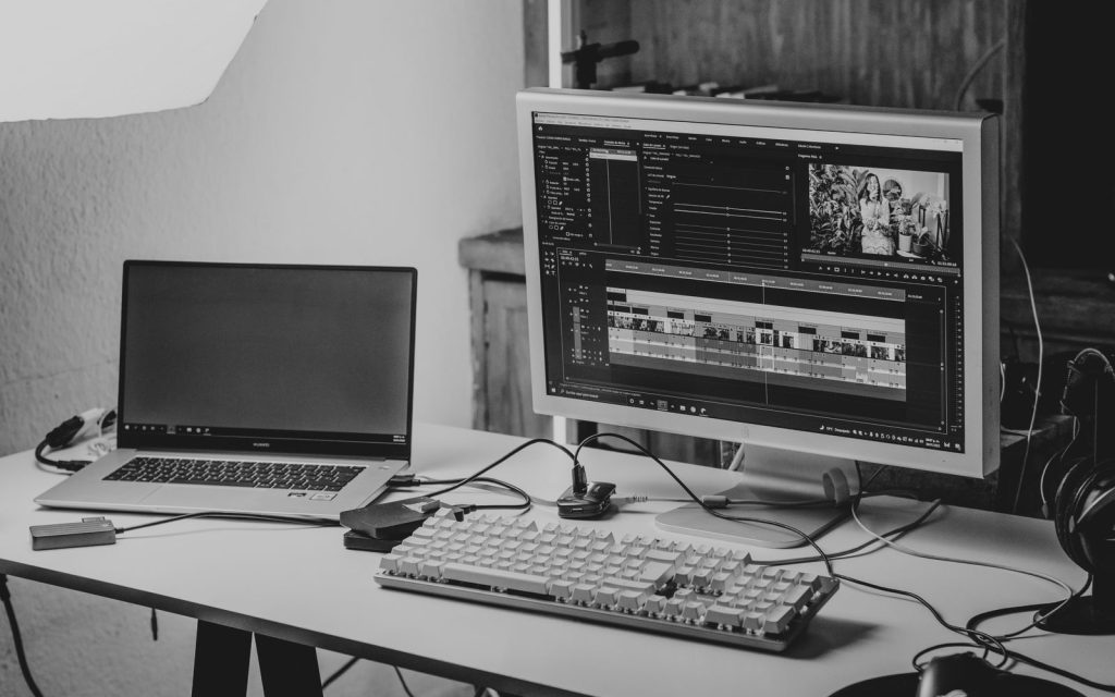 Desk with laptop and monitor for video editing