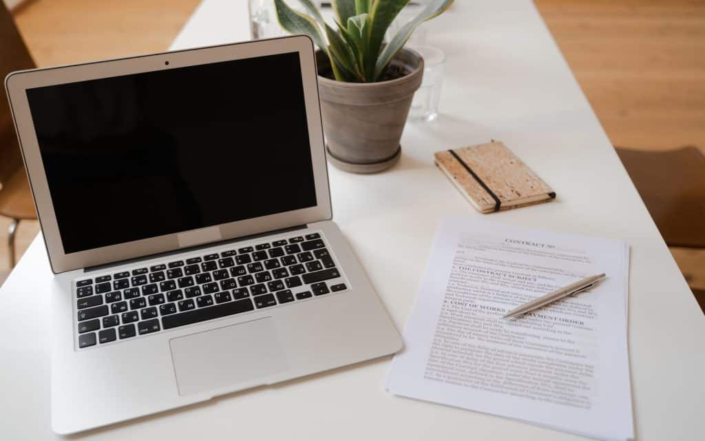 Laptop and printed documents on a desk