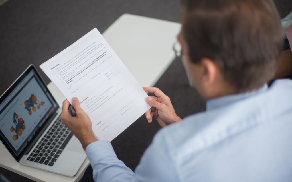 Man reviewing printed documents