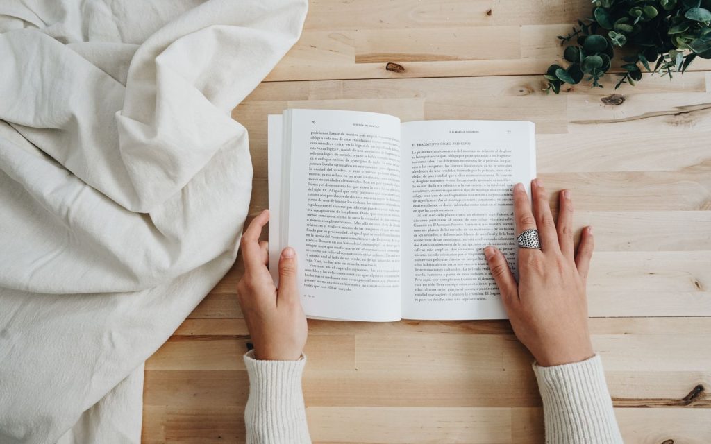 Person holding an open book