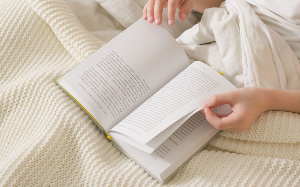 Person turning the pages of a book