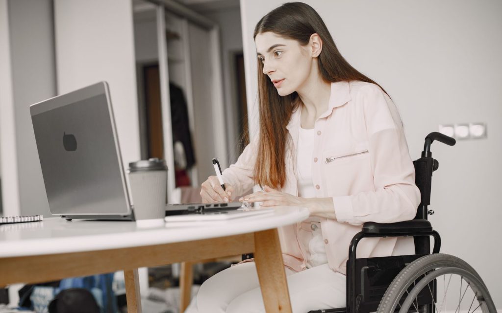 Professional in a wheelchair working on a laptop