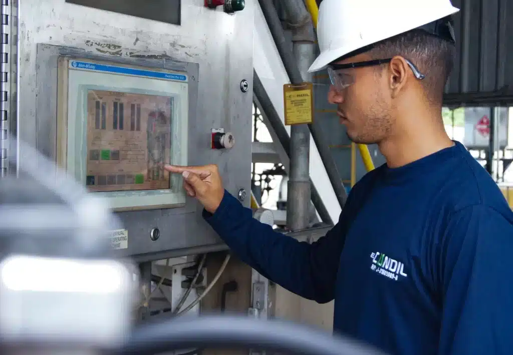 Engineer operating the control panel of industrial machinery